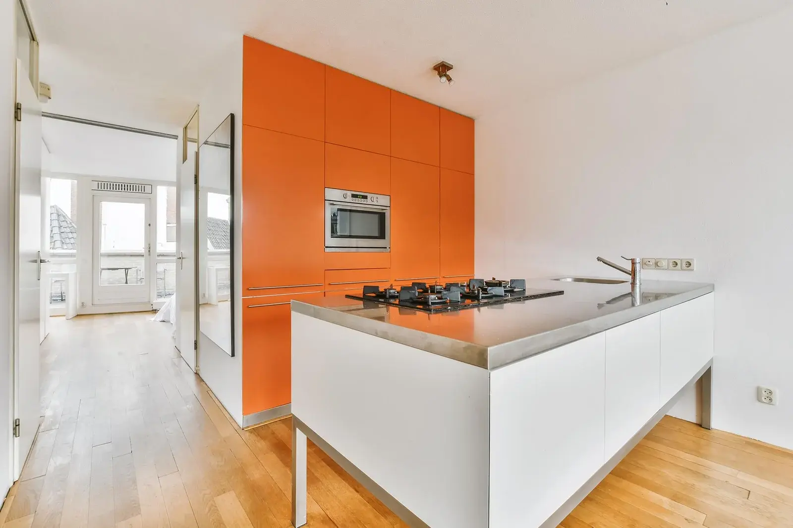 Canterwood 1 KITCHEN REMODELING TACOMA WA featuring modern orange cabinetry and a white minimalist island