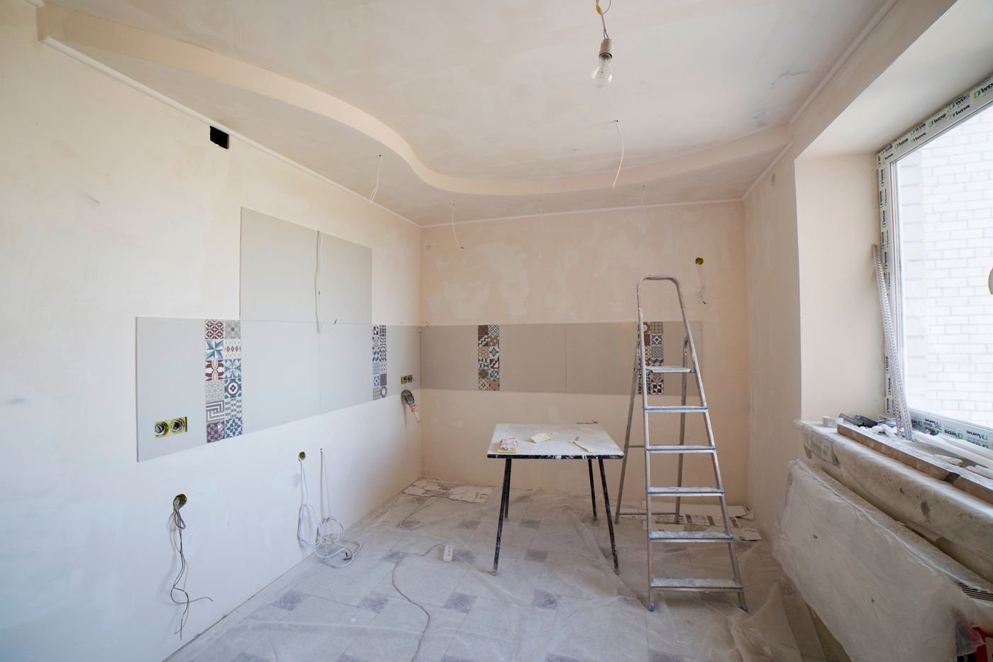 Kitchen wall demolition exposing framing during a Tacoma remodel